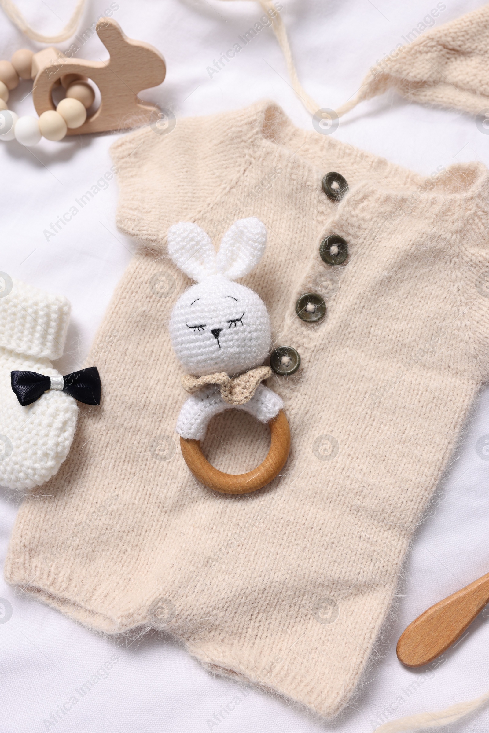 Photo of Different baby accessories on white fabric, above view