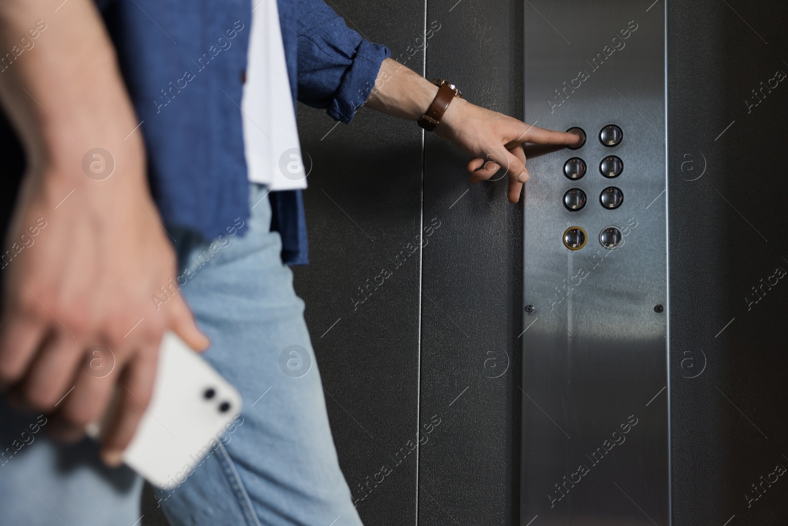 Photo of Man choosing floor in elevator, closeup view