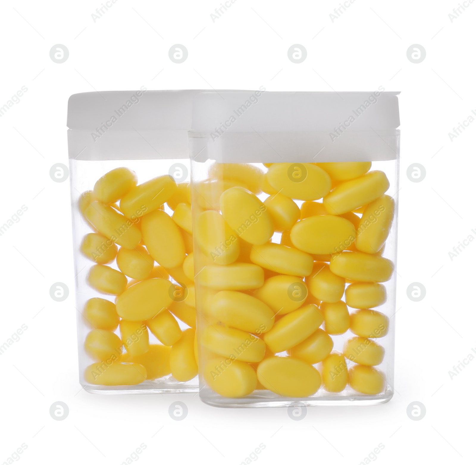 Photo of Boxes of tasty yellow dragee candies on white background