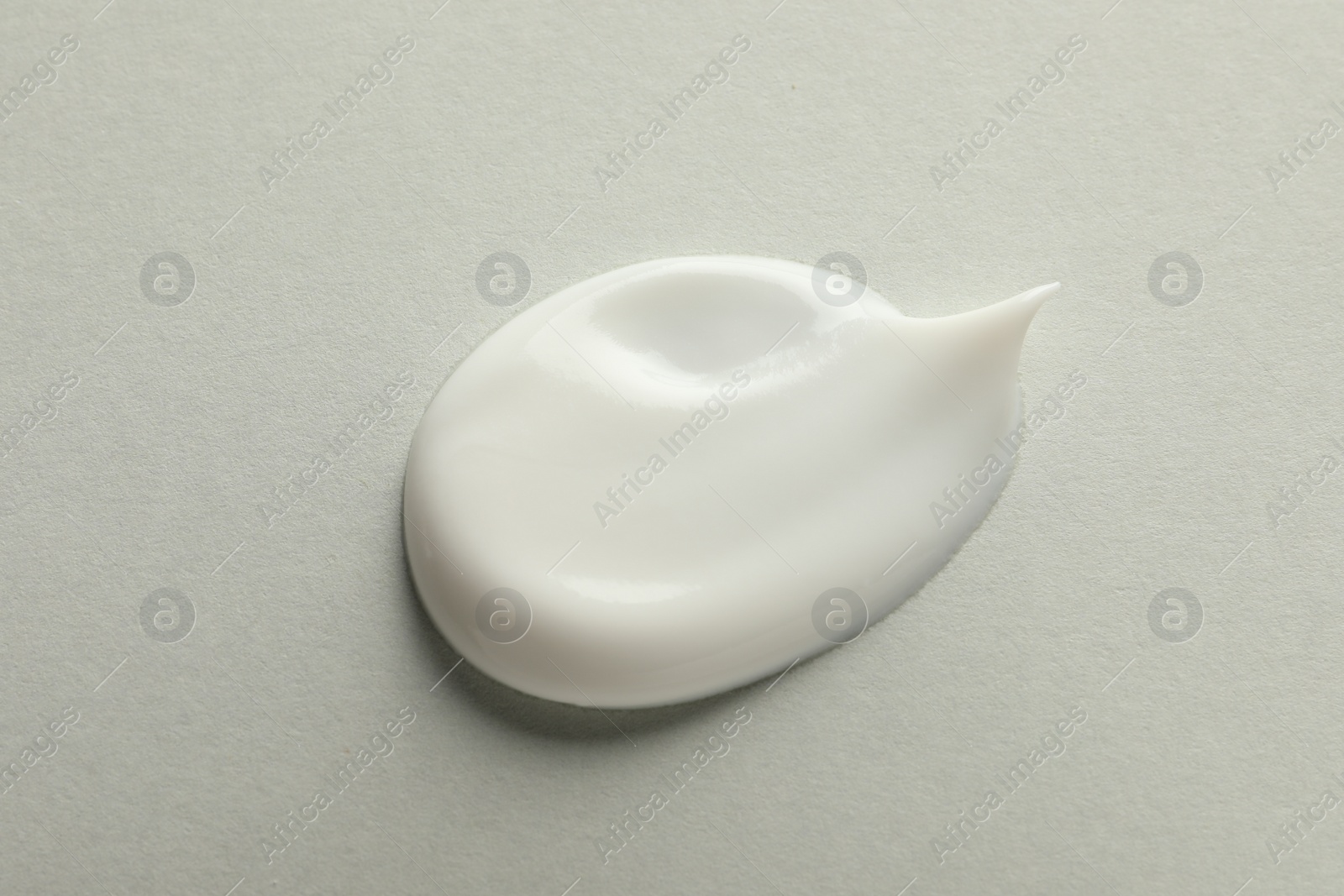 Photo of Sample of face cream on light background, top view