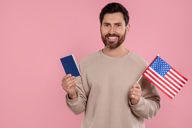 Photo of Immigration. Happy man with passport and American flag on pink background, space for text
