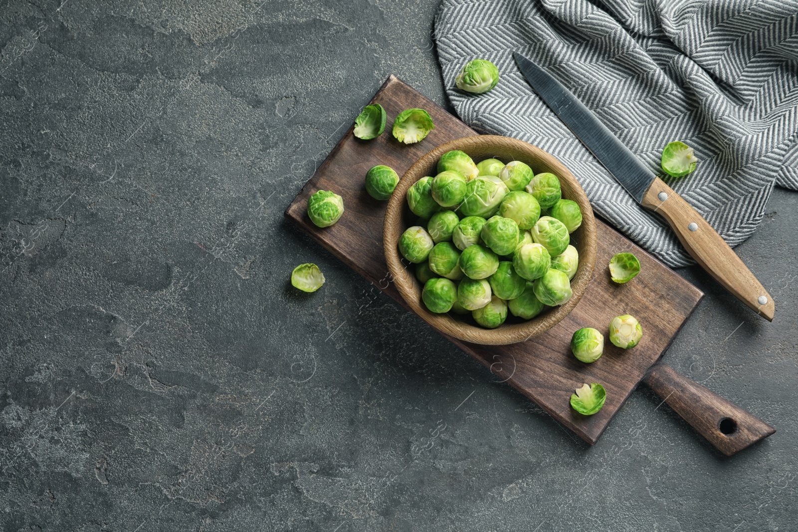 Photo of Composition with bowl of Brussels sprouts on grey background, flat lay. Space for text