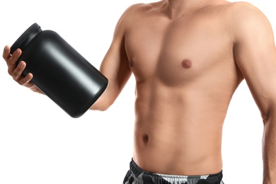 Athletic man with big black jar on white background, closeup. Doping concept