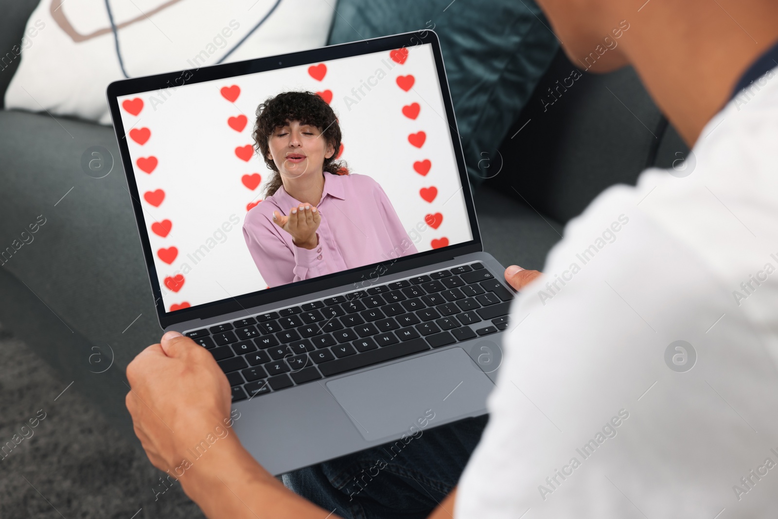 Image of Long distance love. Man having video chat with his girlfriend via laptop at home, closeup