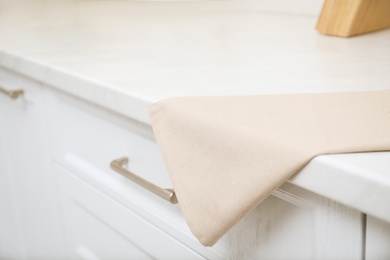 Clean kitchen towel on counter at home, closeup