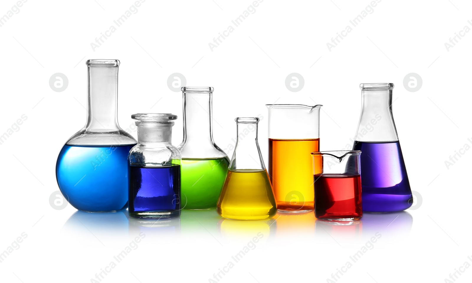 Photo of Set of different lab glassware with color liquid isolated on white