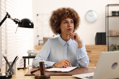 Notary with clipboard and pen at workplace in office