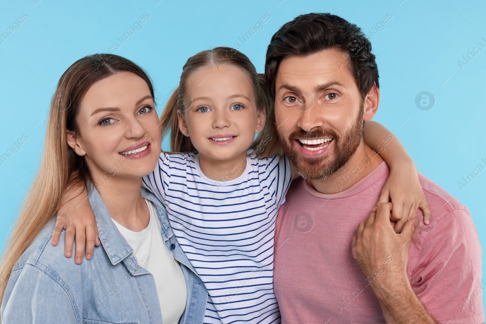 Photo of Happy family together on light blue background