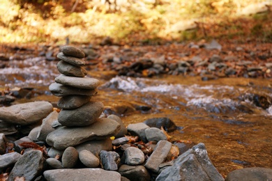 Photo of Stack of stones near water. Space for text