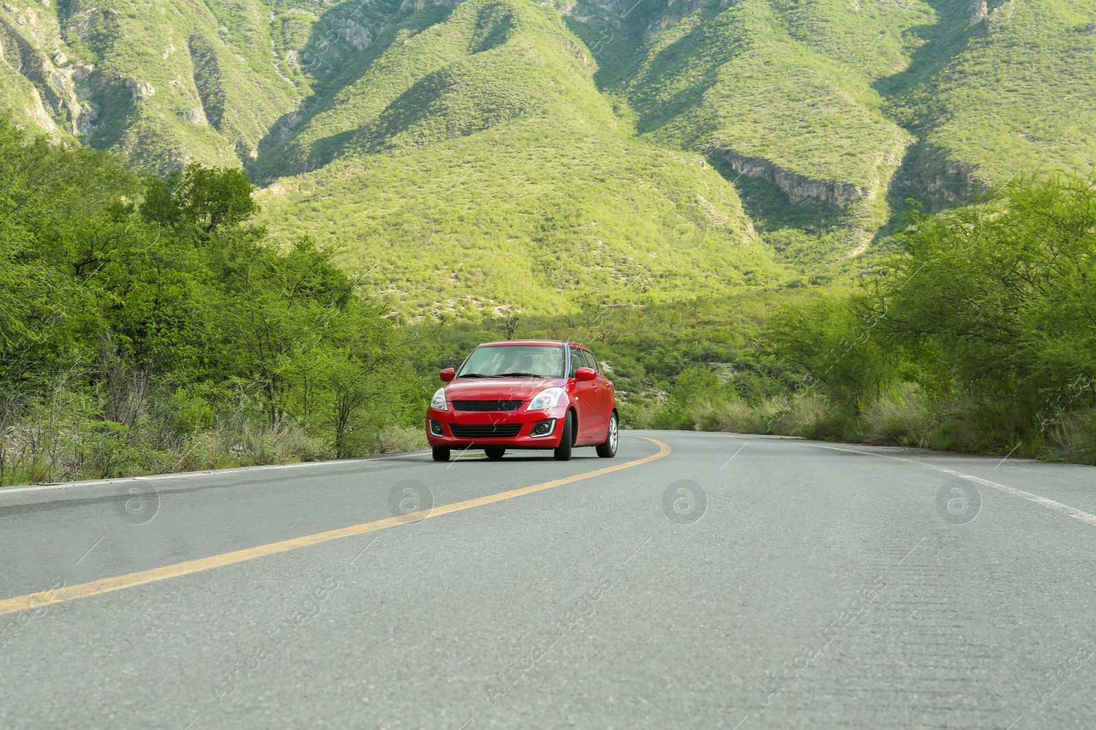 Photo of Beautiful view of car on asphalt highway in mountains. Road trip