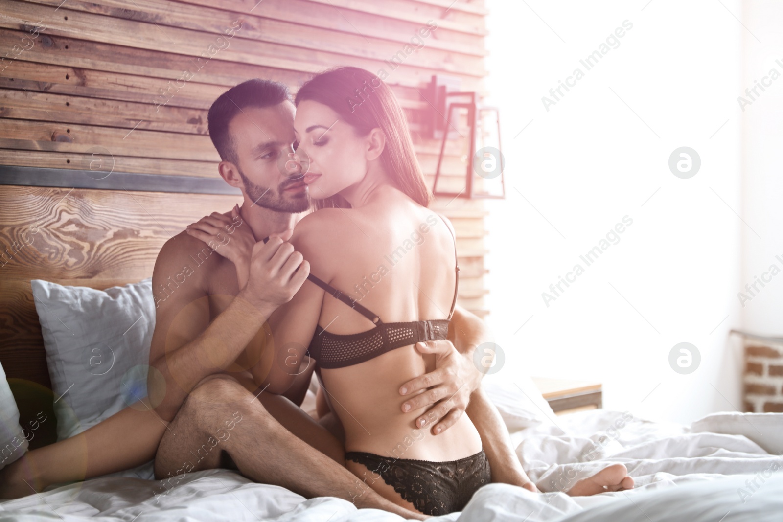 Image of Passionate young couple having sex in bed at home