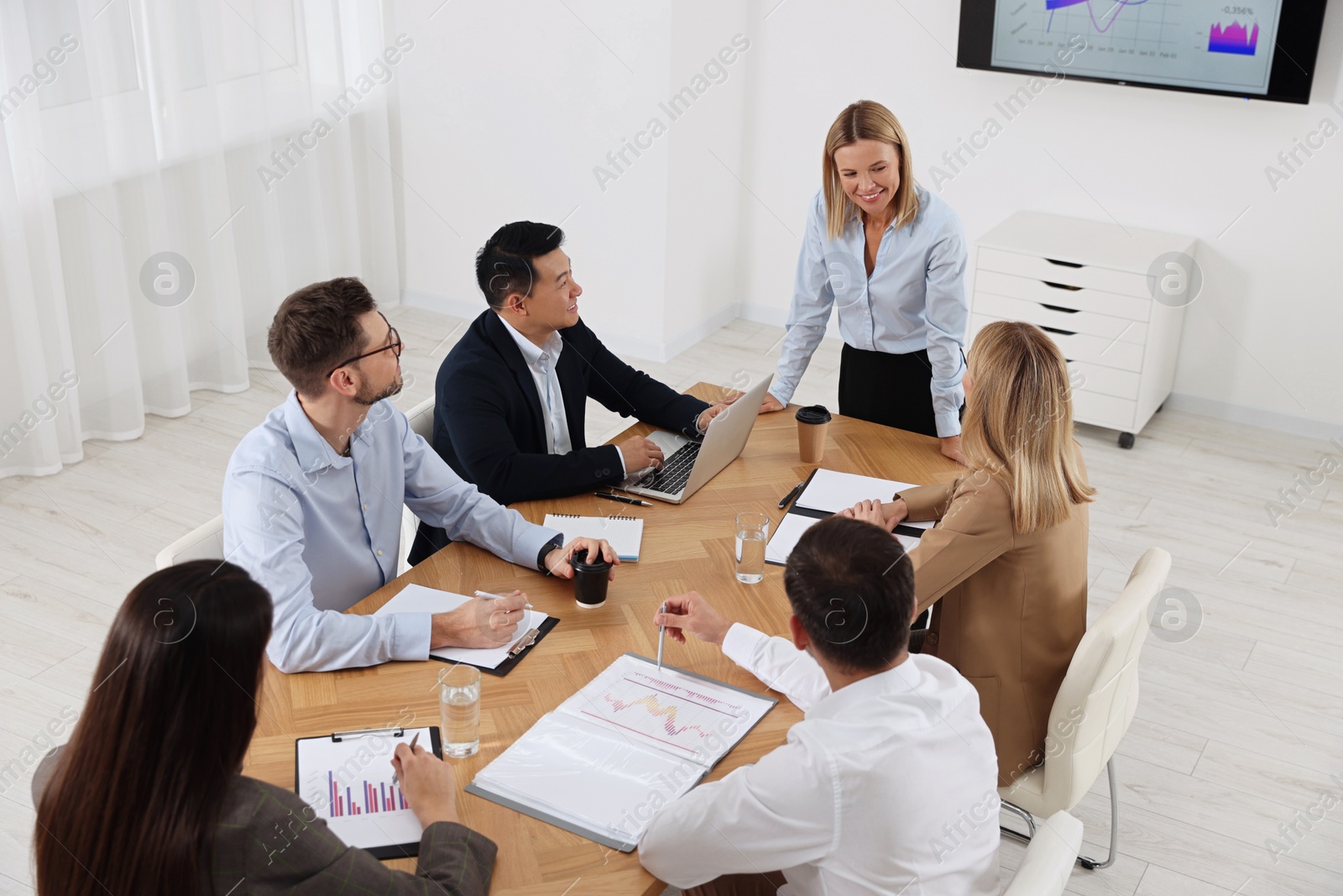 Photo of Businesswoman having meeting with her employees in office