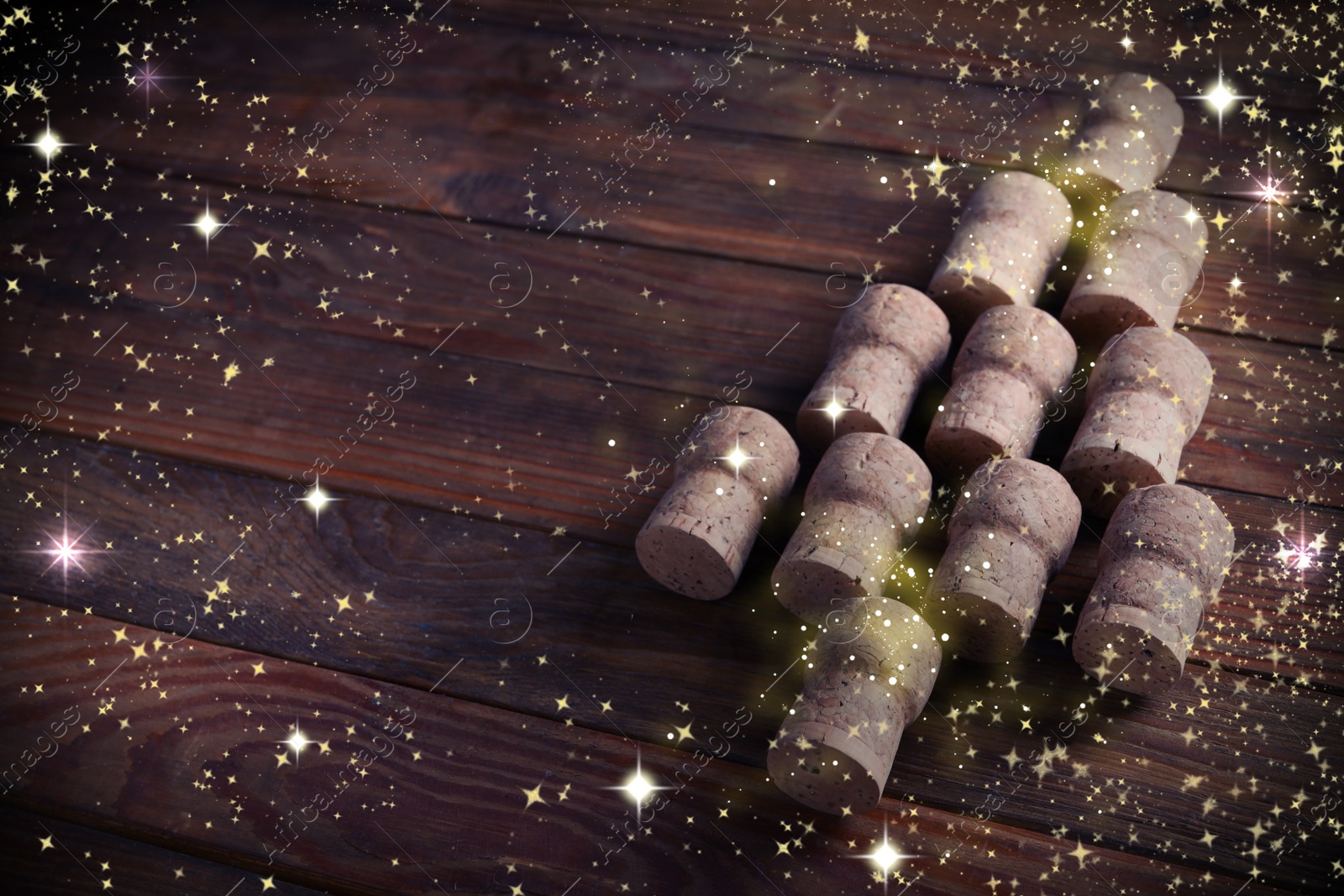 Image of Christmas tree made of sparkling wine corks on wooden table. Space for text