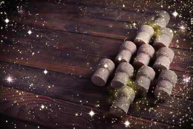 Image of Christmas tree made of sparkling wine corks on wooden table. Space for text