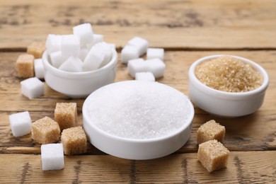 Photo of Different types of sugar on wooden table