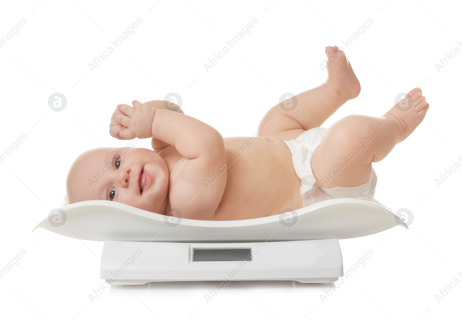 Photo of Cute little baby lying on scales against white background