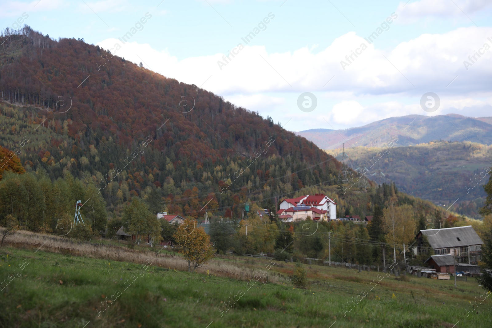 Photo of Picturesque view of houses and trees in mountains