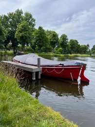 Beautiful view of canal with moored boat on sunny day