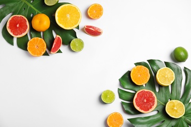 Different citrus fruits on white background, flat lay. Space for text