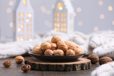 Homemade walnut shaped cookies with boiled condensed milk on wooden table. Bokeh effect