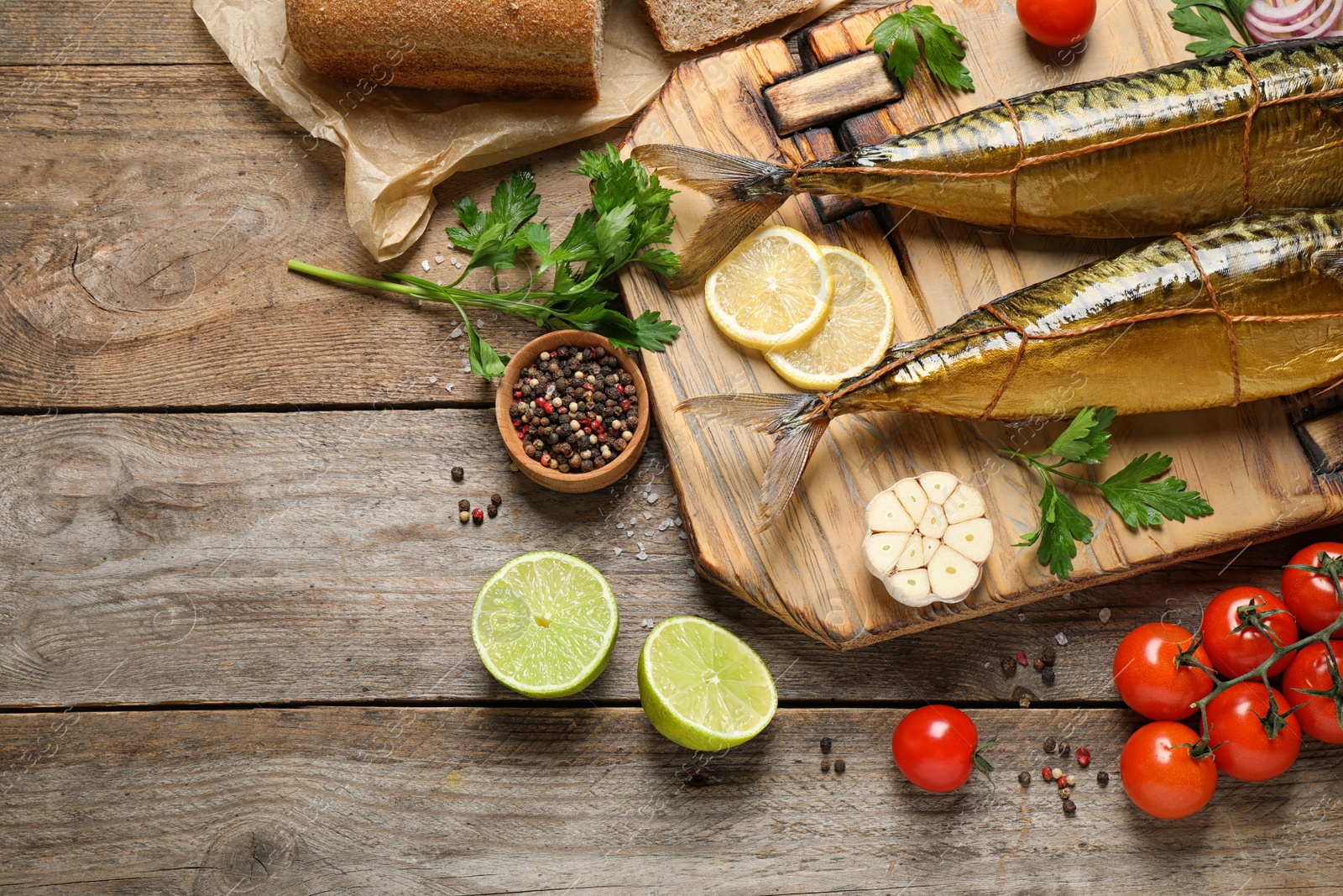 Photo of Flat lay composition with tasty smoked fish on wooden table