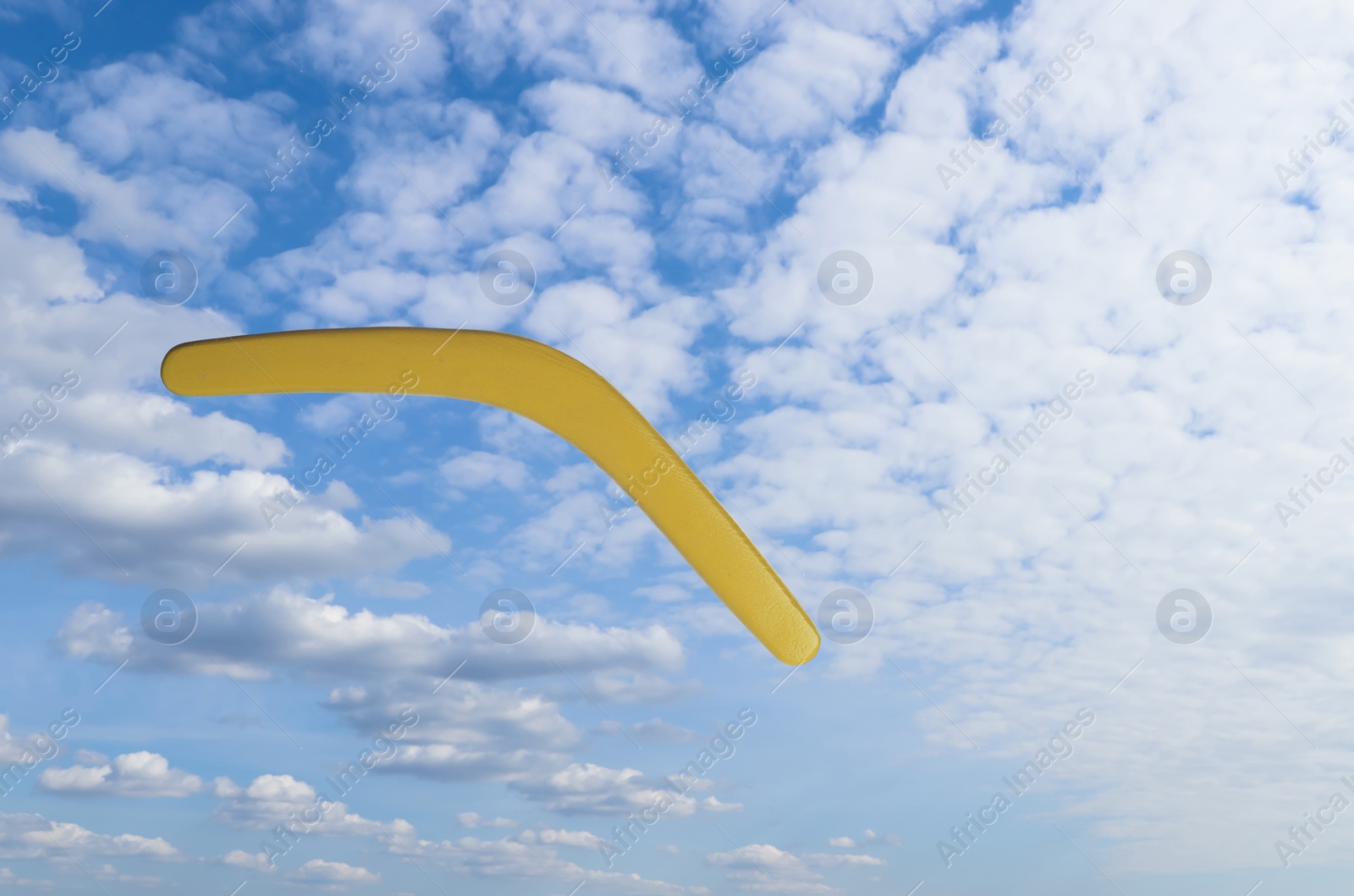 Image of Throwing of boomerang against blue sky. Outdoor activity 