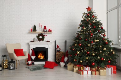 Photo of Beautiful Christmas themed photo zone with tree and fireplace in room