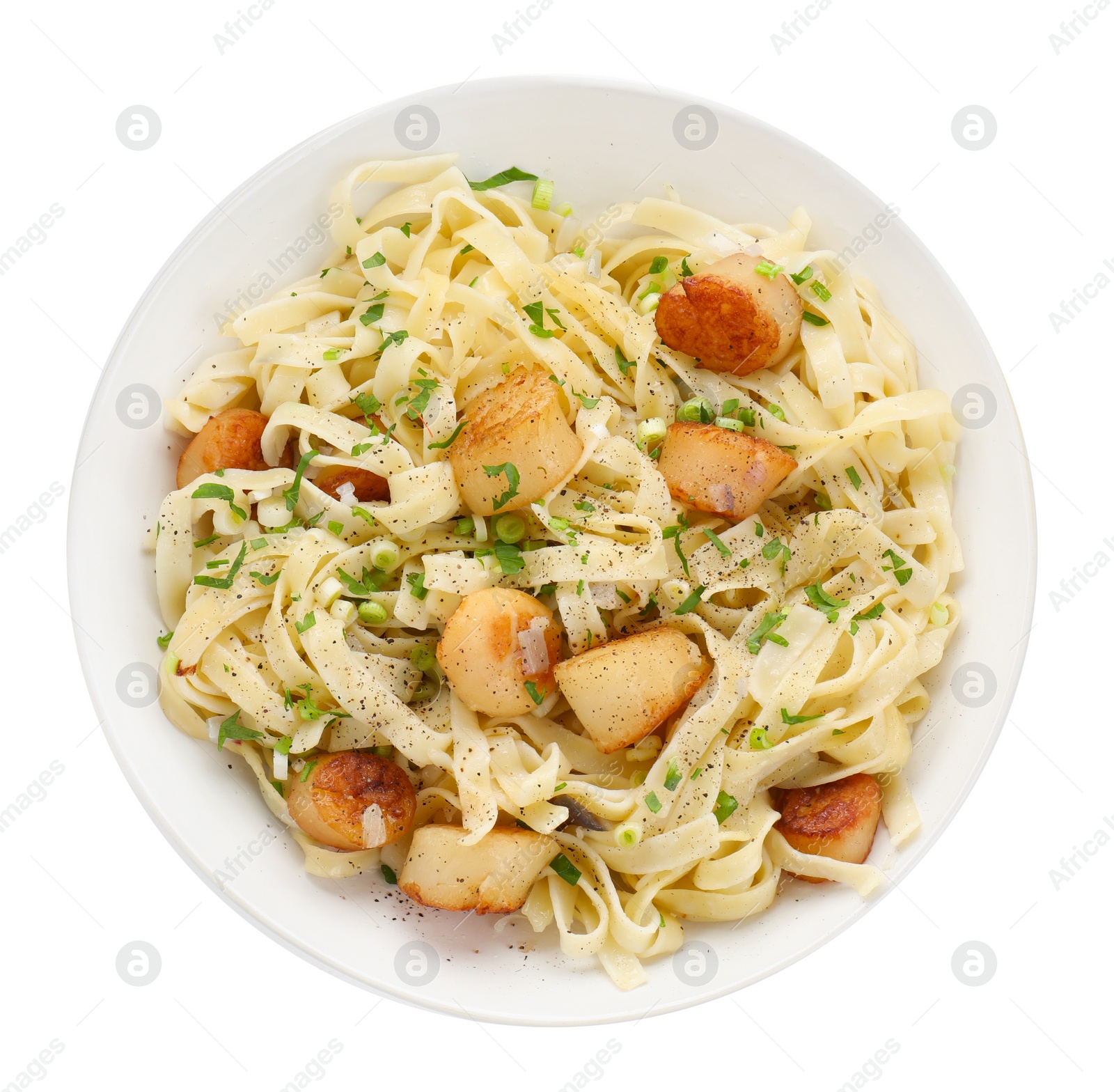 Photo of Delicious scallop pasta with spices in bowl isolated on white, top view