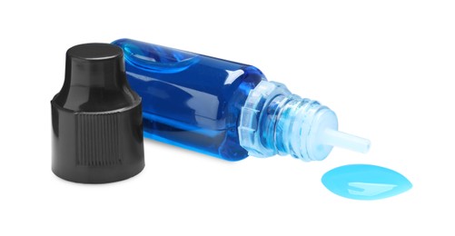 Photo of Bottle of blue food coloring on white background