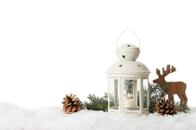 Beautiful composition with vintage Christmas lantern and festive decorations on snow against white background. Space for text