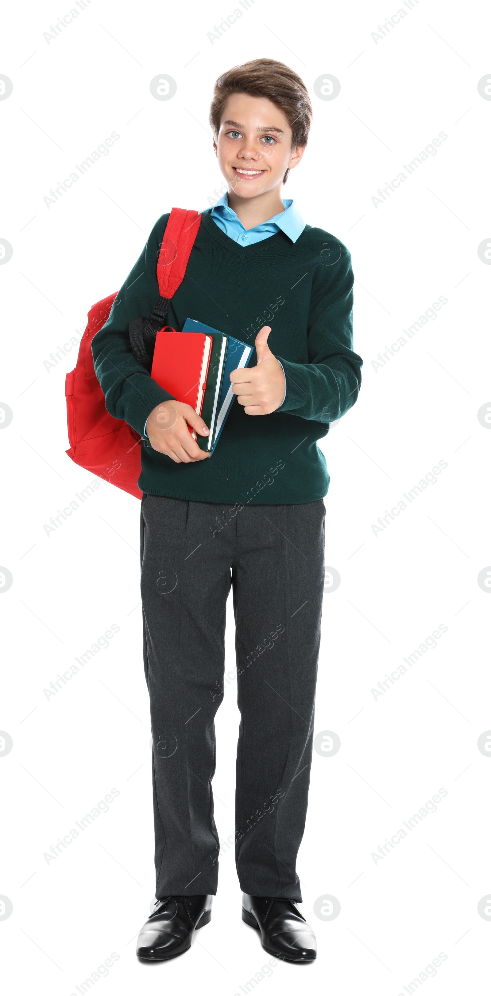 Photo of Happy boy in school uniform on white background