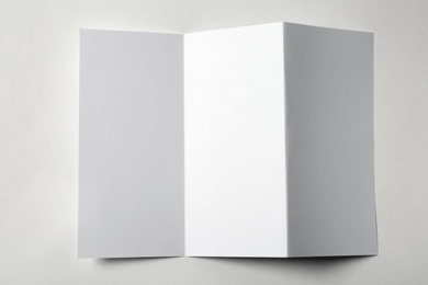 Photo of Blank brochure on white background, above view. Mock up for design