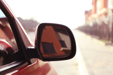 Photo of Side rear view mirror of modern car outdoors