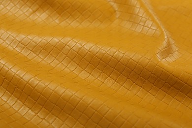 Photo of Beautiful yellow leather as background, closeup view