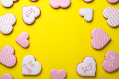 Photo of Frame made of cookies on yellow background, flat lay with space for text. Valentine's day treat