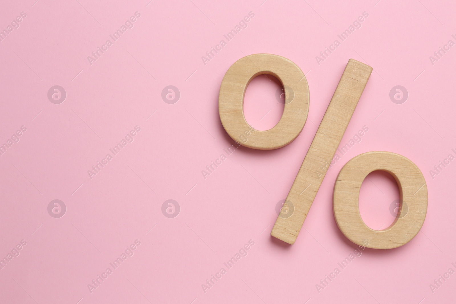 Photo of Wooden percent sign on pink background, flat lay. Space for text