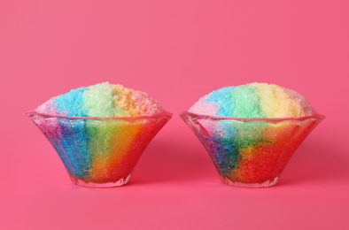 Photo of Rainbow shaving ice in glass dessert bowls on pink background