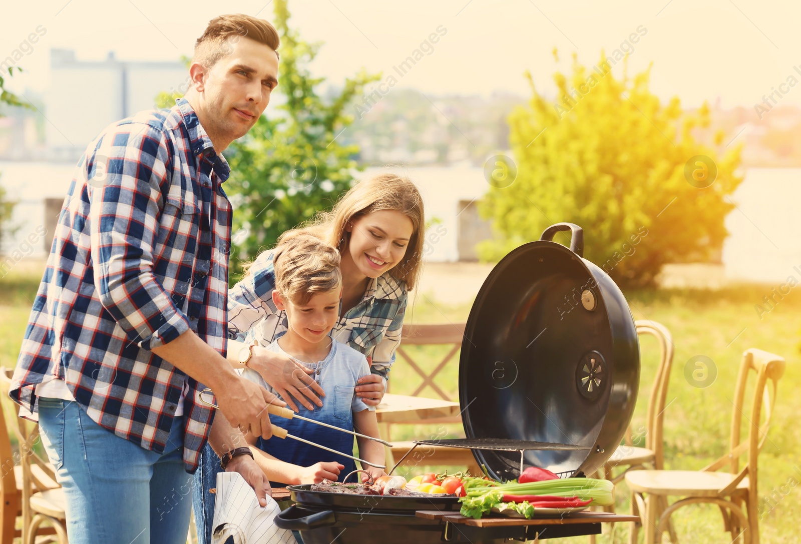Image of Happy family having barbecue with modern grill outdoors on sunny day