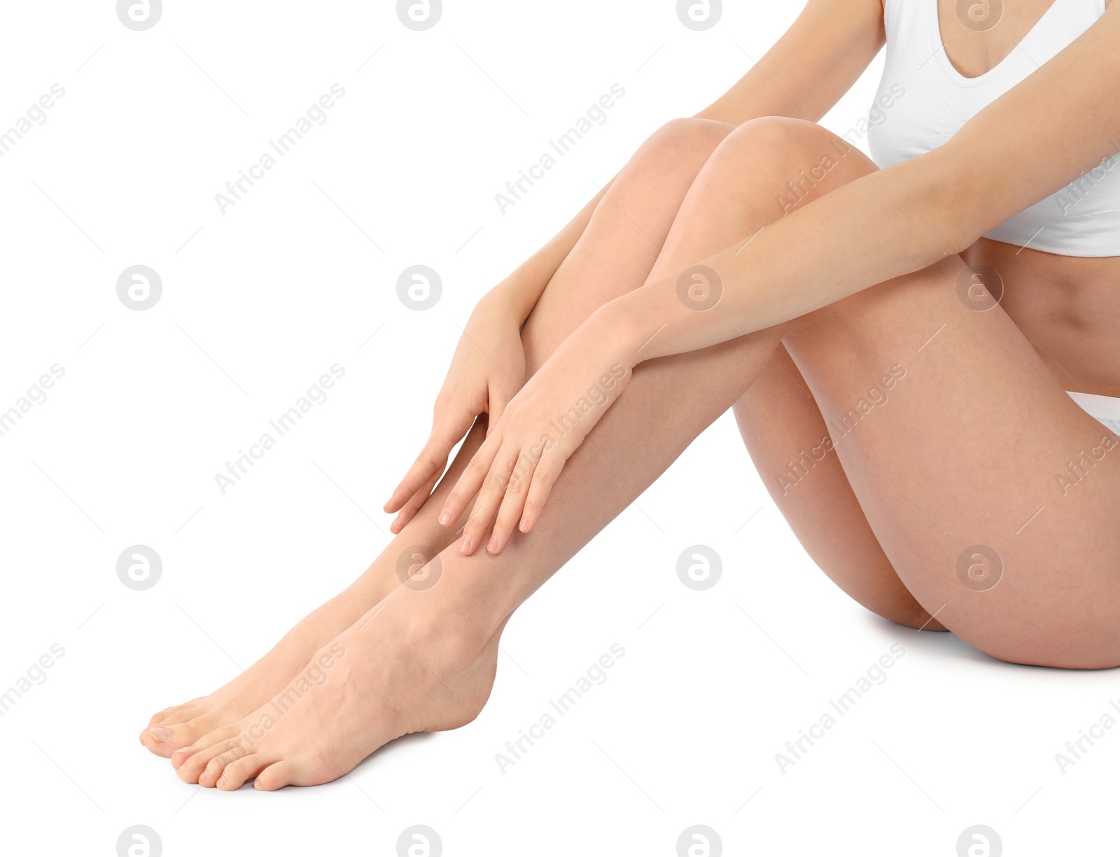 Photo of Young woman with perfect smooth skin on white background, closeup of legs. Beauty and body care