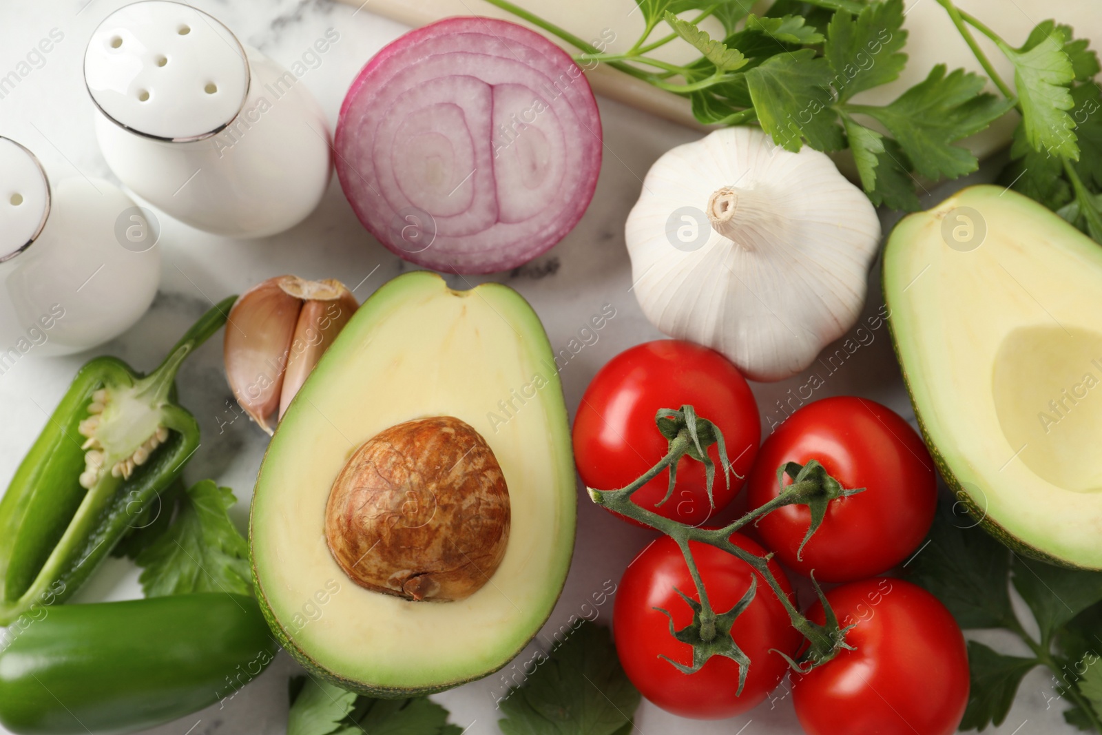 Photo of Fresh ingredients for guacamole on white table, flat lay