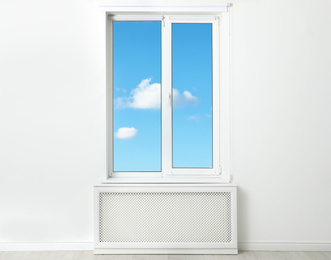 Image of Beautiful view on blue sky with clouds through window in room