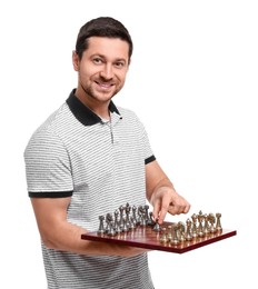 Smiling man holding chessboard with game pieces on white background