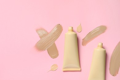 Liquid foundations and swatches on pink background, flat lay. Space for text