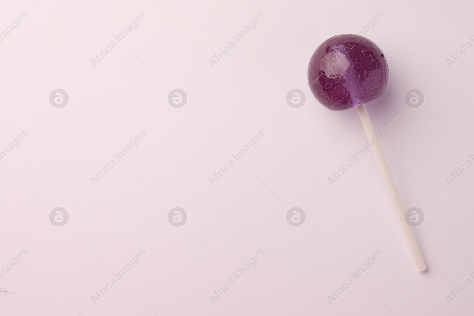 Photo of Tasty lollipop on white background, top view. Space for text