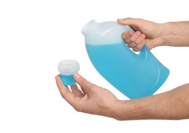 Photo of Man holding cap and bottle of fabric softener for washing clothes on white background, closeup