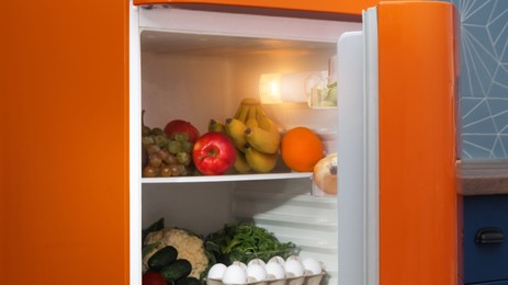 Photo of Open refrigerator full of many different products