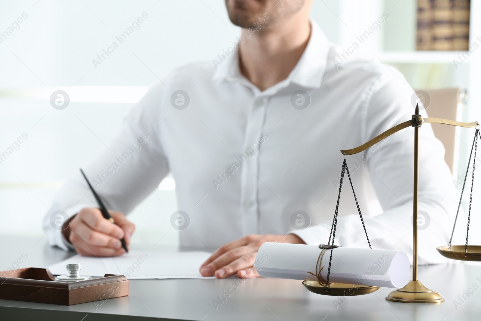 Photo of Male notary working with documents at table indoors, closeup