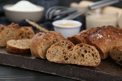 Freshly baked bread on wooden table, closeup