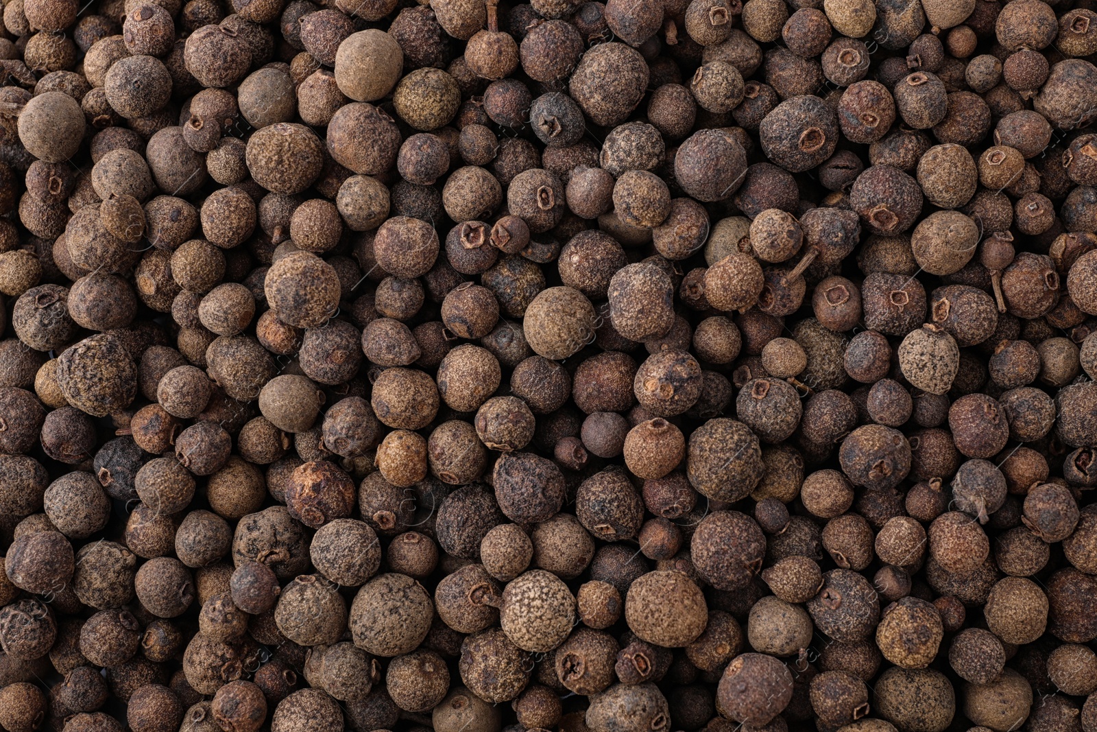 Photo of Black pepper grains as background, top view