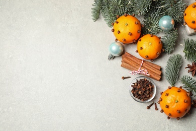 Delicious fresh tangerines and Christmas spices on light table, flat lay. Space for text